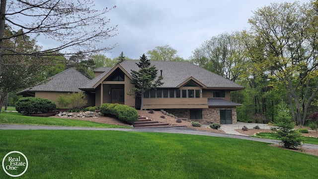 966 Pine Needle Trl, Oakland Twp, MI 48306 - view of front facade with a front yard, stone siding, a shingled roof, and stairs