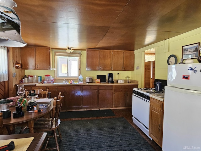 10162 Wyoming Rd, Mohawk, MI 49918 - kitchen with white appliances, a sink, light countertops, and brown cabinets