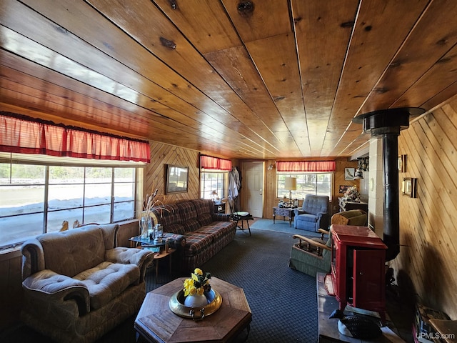 10162 Wyoming Rd, Mohawk, MI 49918 - living area featuring a wood stove, wooden walls, carpet flooring, and wooden ceiling