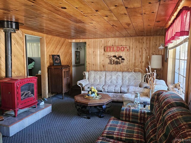 10162 Wyoming Rd, Mohawk, MI 49918 - living area featuring wood ceiling, a wood stove, carpet floors, and wooden walls