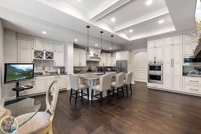60330 Mount Vernon Rd, Washington Twp, MI 48306 - kitchen with stainless steel appliances, crown molding, arched walkways, backsplash, and a kitchen bar