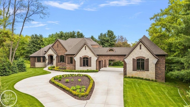 60330 Mount Vernon Rd, Washington Twp, MI 48306 - french provincial home featuring stone siding, brick siding, a front yard, and roof with shingles