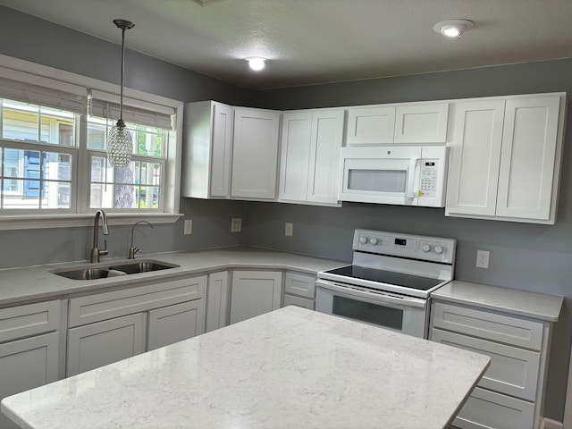 3214 Elnor Dr, Gladwin, MI 48624 - kitchen with white appliances, a sink, white cabinets, and pendant lighting