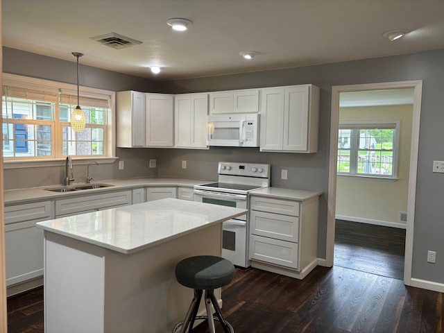 3214 Elnor Dr, Gladwin, MI 48624 - kitchen with white appliances, a sink, plenty of natural light, and white cabinets