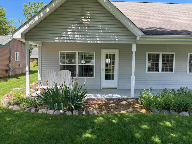 3214 Elnor Dr, Gladwin, MI 48624 - rear view of property with covered porch and a lawn