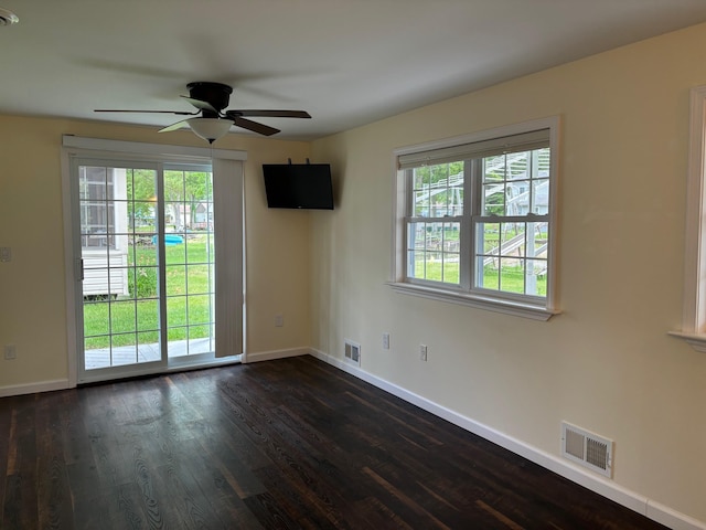 3214 Elnor Dr, Gladwin, MI 48624 - unfurnished room featuring healthy amount of natural light, a ceiling fan, baseboards, and dark wood-style flooring