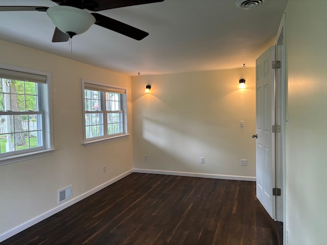3214 Elnor Dr, Gladwin, MI 48624 - empty room featuring dark wood finished floors, healthy amount of natural light, and baseboards