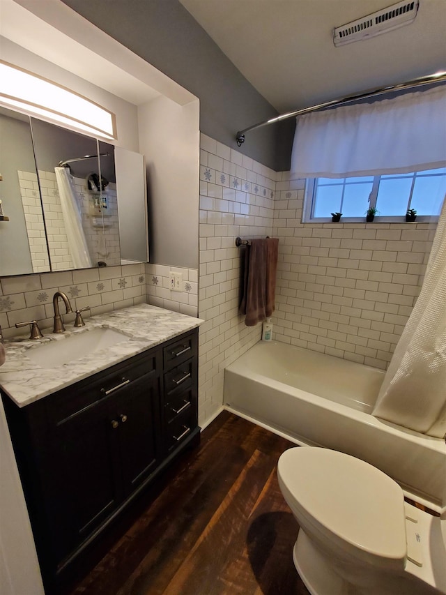 3214 Elnor Dr, Gladwin, MI 48624 - bathroom with shower / tub combo, vanity, toilet, wood finished floors, and tasteful backsplash