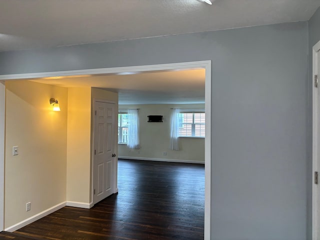 3214 Elnor Dr, Gladwin, MI 48624 - unfurnished room featuring baseboards and dark wood-type flooring