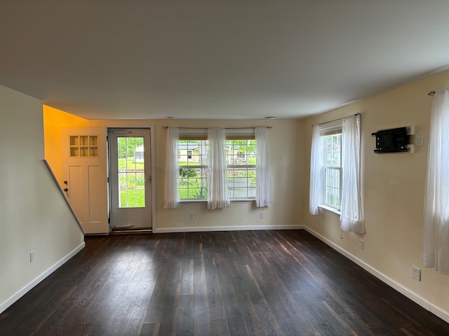 3214 Elnor Dr, Gladwin, MI 48624 - spare room featuring dark wood-style flooring and baseboards