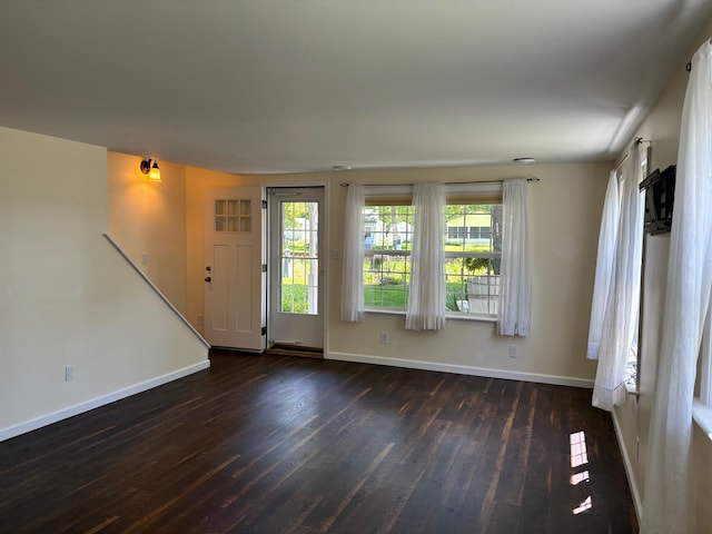3214 Elnor Dr, Gladwin, MI 48624 - unfurnished living room with dark wood-type flooring and baseboards