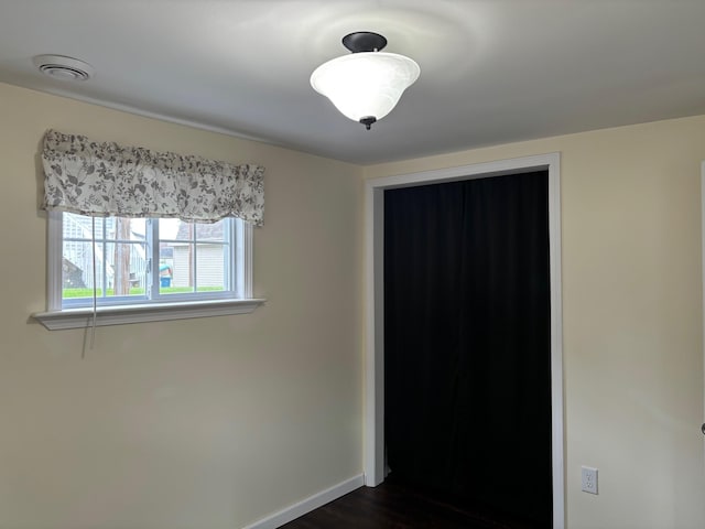 3214 Elnor Dr, Gladwin, MI 48624 - unfurnished bedroom with dark wood finished floors and baseboards
