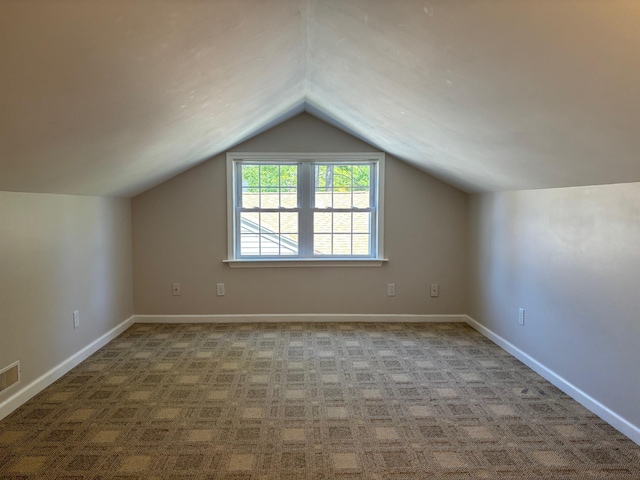 3214 Elnor Dr, Gladwin, MI 48624 - bonus room featuring carpet floors, lofted ceiling, and baseboards