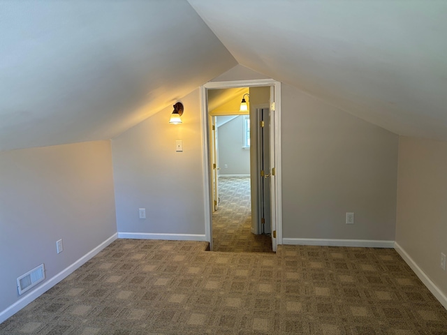 3214 Elnor Dr, Gladwin, MI 48624 - additional living space with carpet floors, vaulted ceiling, and baseboards