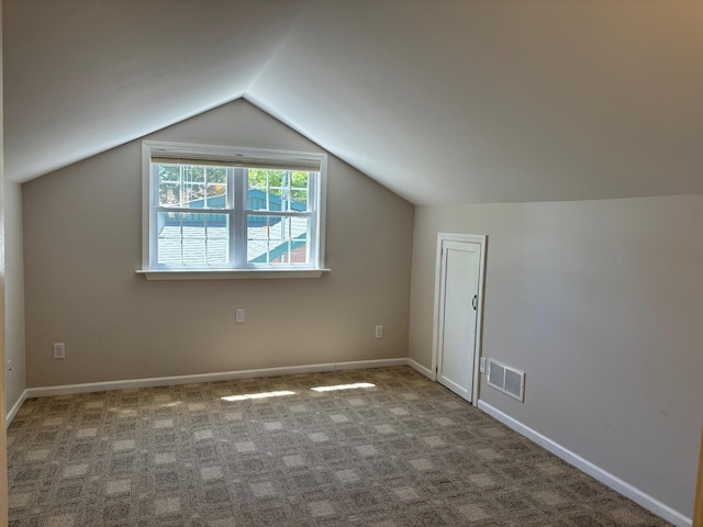 3214 Elnor Dr, Gladwin, MI 48624 - bonus room featuring lofted ceiling, carpet flooring, and baseboards