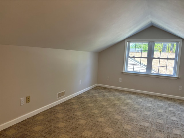3214 Elnor Dr, Gladwin, MI 48624 - additional living space featuring vaulted ceiling, carpet, and baseboards