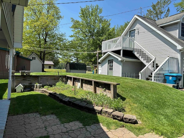3214 Elnor Dr, Gladwin, MI 48624 - view of green lawn featuring a wooden deck and stairway