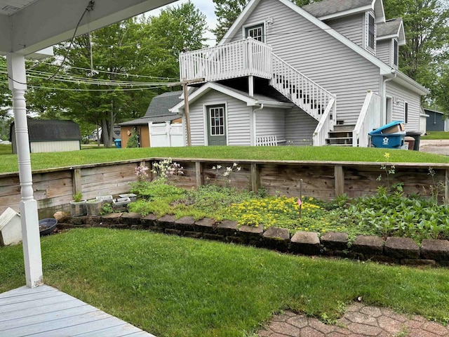 3214 Elnor Dr, Gladwin, MI 48624 - view of side of home featuring a wooden deck, roof with shingles, and a garage