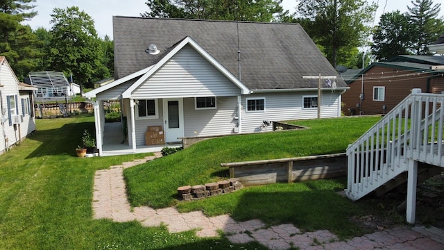 3214 Elnor Dr, Gladwin, MI 48624 - rear view of property featuring a lawn, roof with shingles, and stairs