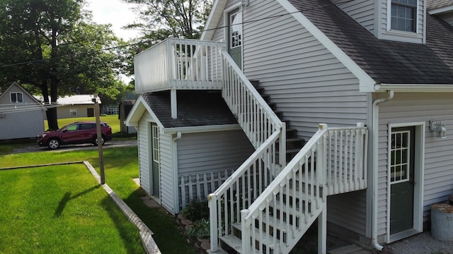 3214 Elnor Dr, Gladwin, MI 48624 - view of side of home with stairs, a lawn, a wooden deck, and roof with shingles
