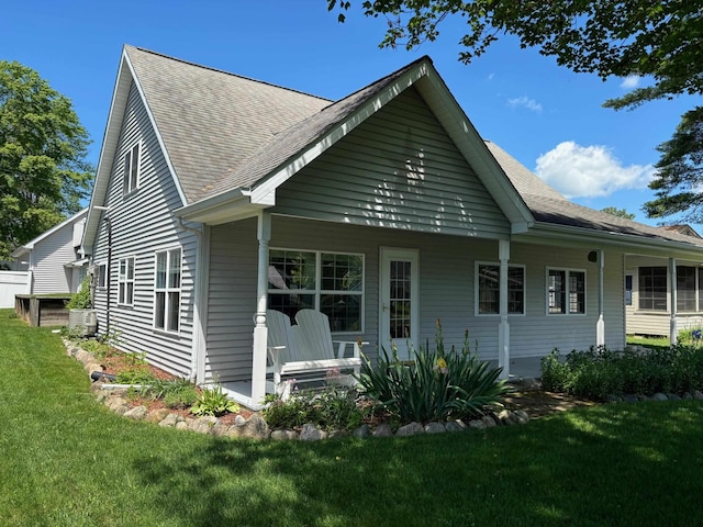 3214 Elnor Dr, Gladwin, MI 48624 - rear view of property with a yard and roof with shingles