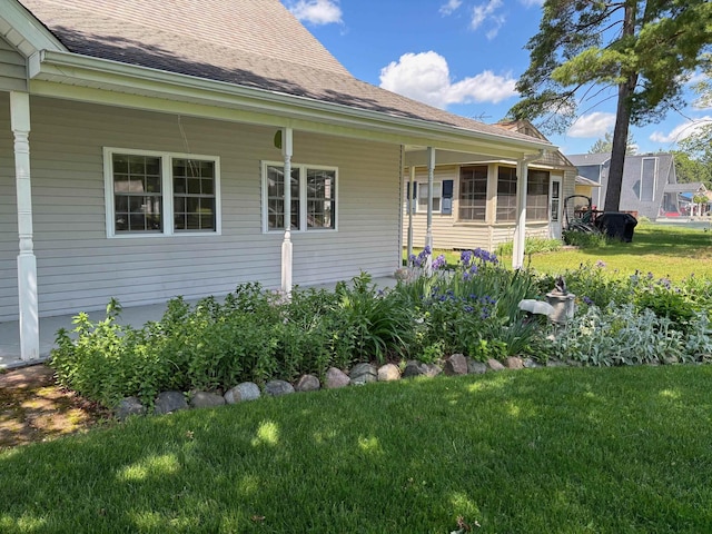 3214 Elnor Dr, Gladwin, MI 48624 - view of property exterior featuring a lawn and roof with shingles