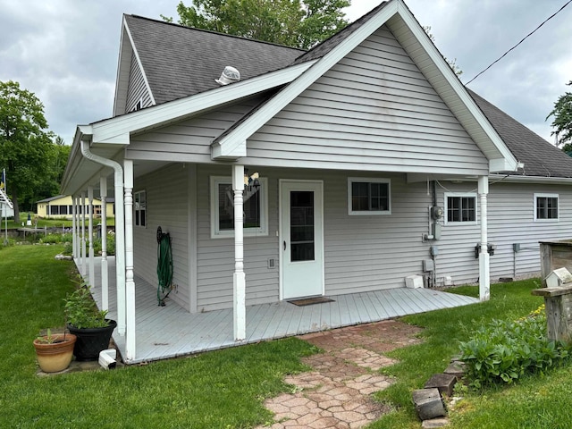 3214 Elnor Dr, Gladwin, MI 48624 - rear view of property featuring a lawn and a shingled roof