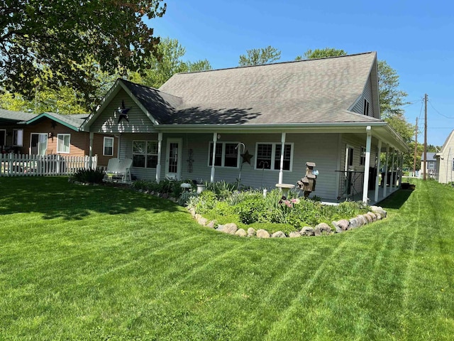 3214 Elnor Dr, Gladwin, MI 48624 - back of house featuring a shingled roof and covered porch