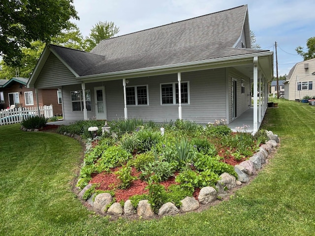 3214 Elnor Dr, Gladwin, MI 48624 - view of front facade featuring a front yard and roof with shingles