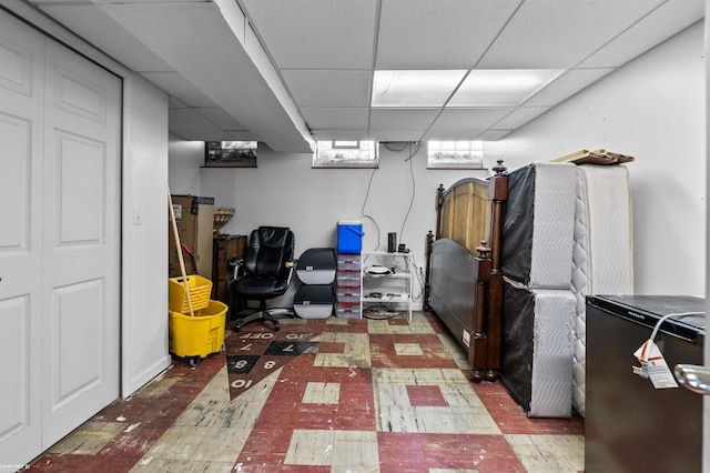 8912 Hubbard St, Livonia, MI 48150 - below grade area with tile patterned floors, a paneled ceiling, and refrigerator