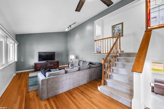 8912 Hubbard St, Livonia, MI 48150 - living room featuring wood finished floors, stairs, ceiling fan, rail lighting, and baseboards