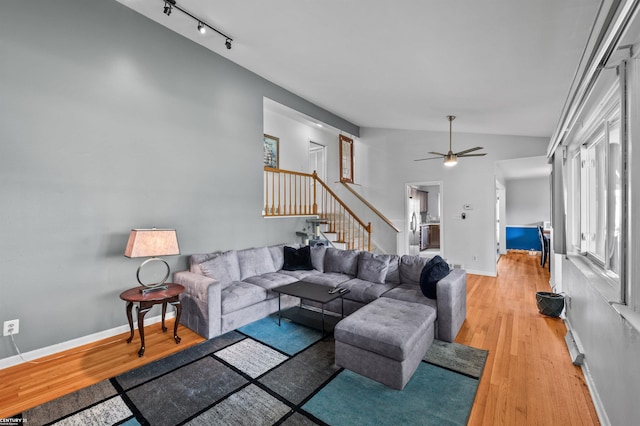 8912 Hubbard St, Livonia, MI 48150 - living room featuring stairs, ceiling fan, light wood-style floors, rail lighting, and baseboards