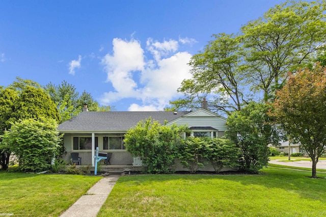 8912 Hubbard St, Livonia, MI 48150 - view of front of home with a front yard, brick siding, and a chimney