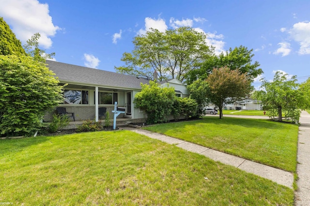 8912 Hubbard St, Livonia, MI 48150 - view of front of house with a front yard, brick siding, and roof with shingles