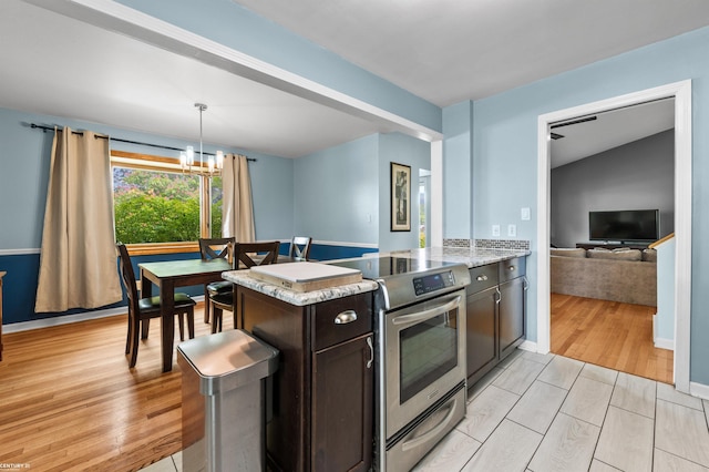 8912 Hubbard St, Livonia, MI 48150 - kitchen featuring stainless steel electric range oven, dark brown cabinetry, light wood finished floors, a chandelier, and decorative light fixtures