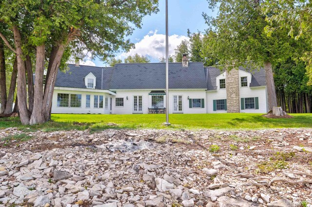 7975 00.25 Rd, Garden, MI 49835 - rear view of house with a lawn, a chimney, and a shingled roof