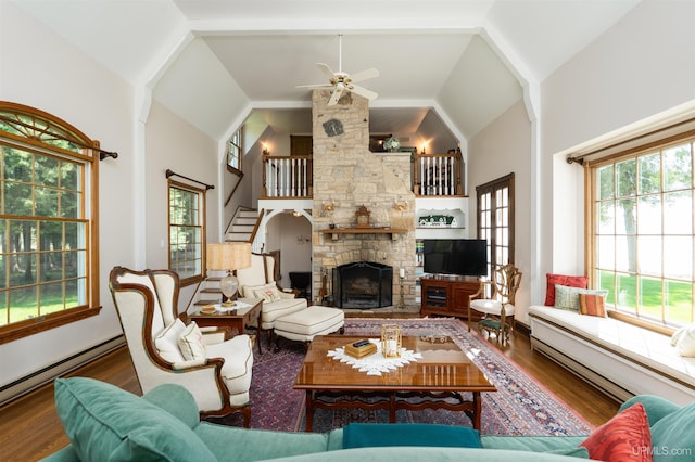 7975 00.25 Rd, Garden, MI 49835 - living area with a ceiling fan, wood finished floors, a baseboard heating unit, stairway, and a fireplace