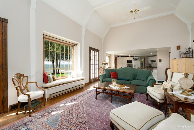 7975 00.25 Rd, Garden, MI 49835 - living area with a baseboard radiator, wood finished floors, high vaulted ceiling, a ceiling fan, and baseboards