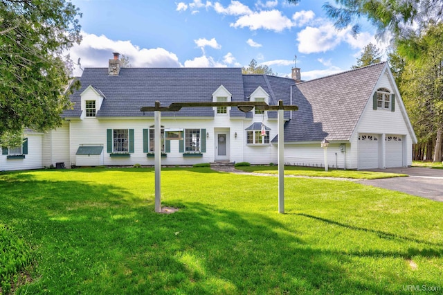 7975 00.25 Rd, Garden, MI 49835 - view of front facade with a chimney, an attached garage, driveway, and a front lawn