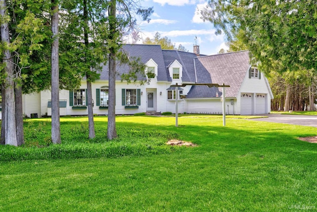 7975 00.25 Rd, Garden, MI 49835 - cape cod house featuring driveway, a chimney, an attached garage, and a front yard