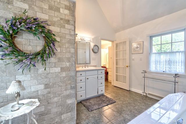 7975 00.25 Rd, Garden, MI 49835 - bathroom featuring tile patterned flooring, vanity, high vaulted ceiling, and baseboards