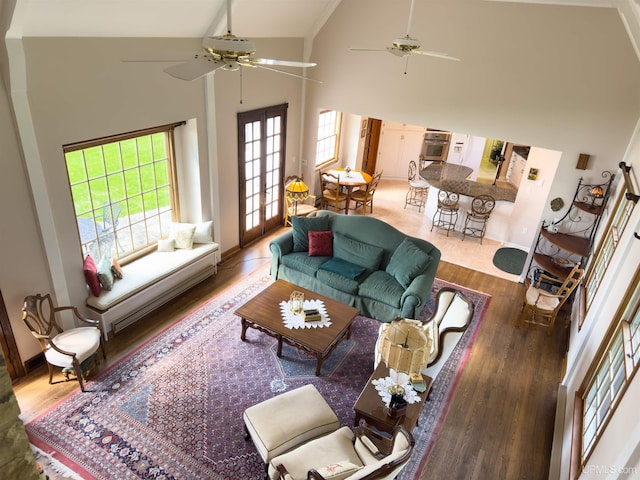 7975 00.25 Rd, Garden, MI 49835 - living area with ceiling fan, high vaulted ceiling, wood finished floors, and baseboards