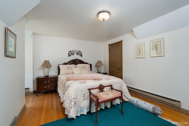 7975 00.25 Rd, Garden, MI 49835 - bedroom with baseboard heating and light wood-type flooring