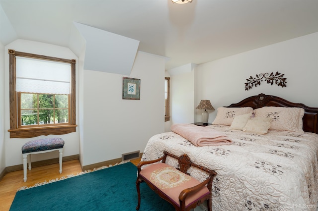 7975 00.25 Rd, Garden, MI 49835 - bedroom featuring vaulted ceiling, wood finished floors, and baseboards