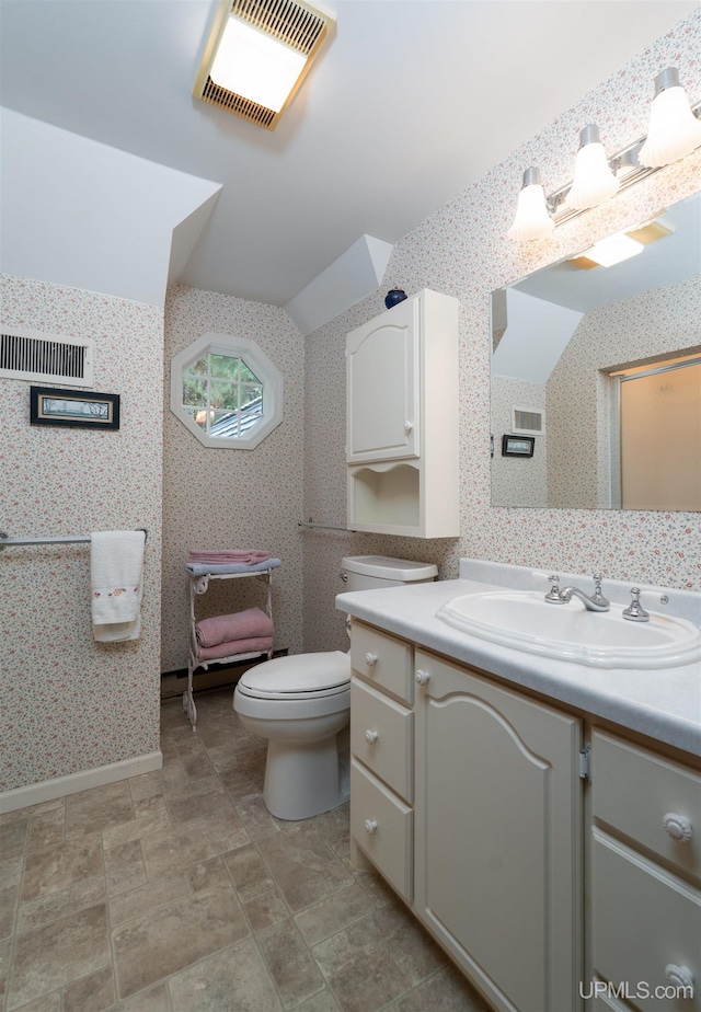 7975 00.25 Rd, Garden, MI 49835 - bathroom featuring vanity, toilet, lofted ceiling, and wallpapered walls