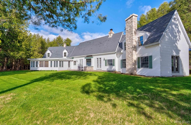 7975 00.25 Rd, Garden, MI 49835 - back of house featuring a chimney and a yard