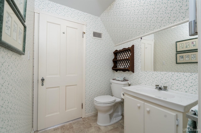 7975 00.25 Rd, Garden, MI 49835 - bathroom featuring wallpapered walls, vanity, and toilet