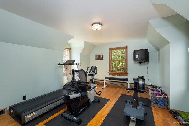 7975 00.25 Rd, Garden, MI 49835 - exercise area with wood finished floors, baseboard heating, and lofted ceiling