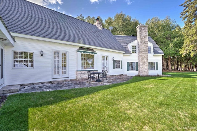 7975 00.25 Rd, Garden, MI 49835 - back of house featuring a chimney, a lawn, a patio area, and french doors