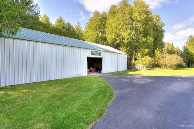 7975 00.25 Rd, Garden, MI 49835 - detached garage featuring asphalt driveway